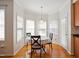 Bright breakfast nook featuring hardwood floors, white trim, and lots of natural light from the bay windows at 101 Whitney Ln, Durham, NC 27713