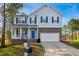 Charming two-story home with stone accents, inviting front porch, and well-manicured landscaping at 101 Whitney Ln, Durham, NC 27713