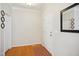 Bright foyer featuring hardwood floors, crown molding, and a stylish mirror at 101 Whitney Ln, Durham, NC 27713