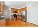 Well-lit kitchen featuring wood cabinets, stainless steel appliances, and plenty of counter space at 101 Whitney Ln, Durham, NC 27713
