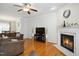 Bright living room with hardwood floors, a fireplace, and neutral decor at 101 Whitney Ln, Durham, NC 27713
