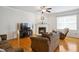 Cozy living room featuring hardwood floors, a fireplace, and a ceiling fan at 101 Whitney Ln, Durham, NC 27713