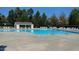 A large community pool with multiple lounge chairs and umbrellas available at 101 Whitney Ln, Durham, NC 27713