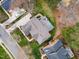 Aerial view of a home with an outdoor deck, landscaping, and a driveway, nestled among neighboring houses at 10841 Round Brook Cir, Raleigh, NC 27617