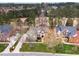 An aerial view shows the traditional home with a long driveway and manicured landscaping near a golf course at 10841 Round Brook Cir, Raleigh, NC 27617