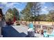 Back deck overlooking the golf course features blue adirondack chairs and outdoor seating at 10841 Round Brook Cir, Raleigh, NC 27617
