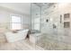 An elegant bathroom showcases a freestanding tub and a glass-enclosed shower at 10841 Round Brook Cir, Raleigh, NC 27617