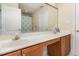 A well-lit bathroom has a double vanity and a shower behind a curtain at 10841 Round Brook Cir, Raleigh, NC 27617