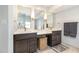 A modern bathroom boasts double sinks, granite countertops, and stylish gold-trimmed mirrors at 10841 Round Brook Cir, Raleigh, NC 27617