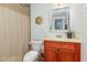 Bathroom showcases a wooden vanity, decorative mirror, neutral wall color and shower with curtain at 10841 Round Brook Cir, Raleigh, NC 27617