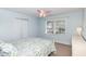 A cozy bedroom features a closet, window and a fan with lights at 10841 Round Brook Cir, Raleigh, NC 27617