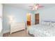 A bright bedroom features neutral wall colors and a connecting door to a bathroom at 10841 Round Brook Cir, Raleigh, NC 27617