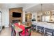 Stylish dining room with modern decor and fireplace, connecting kitchen with breakfast bar at 10841 Round Brook Cir, Raleigh, NC 27617