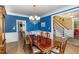 Formal dining room features wainscoting, large windows, hardwood floors, and a chandelier at 10841 Round Brook Cir, Raleigh, NC 27617