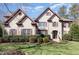 Beautiful, two-story brick home with well-manicured landscaping and a charming, inviting facade at 10841 Round Brook Cir, Raleigh, NC 27617