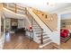 Grand foyer with hardwood floors, a staircase, and an open view to the living room and adjacent room at 10841 Round Brook Cir, Raleigh, NC 27617