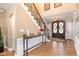 Elegant foyer with hardwood floors, beautiful staircase, and a glimpse of the front entrance at 10841 Round Brook Cir, Raleigh, NC 27617