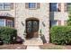 Elegant arched double front doors with sidelights and brick facade create a welcoming entrance at 10841 Round Brook Cir, Raleigh, NC 27617