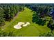 Scenic view of a lush green golf course with mature trees, sand traps, and well-maintained fairways at 10841 Round Brook Cir, Raleigh, NC 27617