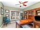 Well-appointed home office with custom wood desk, built-in shelving, and comfortable seating at 10841 Round Brook Cir, Raleigh, NC 27617