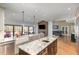 Well-lit kitchen and dining area with granite countertops and stainless steel appliances at 10841 Round Brook Cir, Raleigh, NC 27617