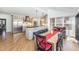 Open kitchen with granite countertops and stainless steel appliances flows to dining area at 10841 Round Brook Cir, Raleigh, NC 27617