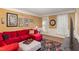 Cozy living room with a red sectional sofa, decorative rug, and ample natural light at 10841 Round Brook Cir, Raleigh, NC 27617