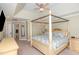 A spacious primary bedroom features a beautiful canopy bed and an ensuite bathroom at 10841 Round Brook Cir, Raleigh, NC 27617
