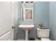 Charming powder room with pedestal sink and classic fixtures at 10841 Round Brook Cir, Raleigh, NC 27617