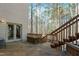 An exterior view of a wooden deck with stairs, a door to the residence, and a natural wooded backdrop at 12117 Cliffside Cir, Raleigh, NC 27614