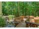 Wood deck with bridge over creek, bench seating, and wooded views creates tranquil outdoor retreat at 12117 Cliffside Cir, Raleigh, NC 27614