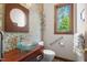Stylish half bath with a glass bowl sink, decorative mosaic wall, modern fixtures, and natural light at 12117 Cliffside Cir, Raleigh, NC 27614