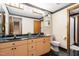 A full bathroom features double sinks, neutral wallpaper, and updated fixtures at 12117 Cliffside Cir, Raleigh, NC 27614