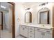 Bright bathroom featuring dual sinks, a skylight, and traditional fixtures at 12117 Cliffside Cir, Raleigh, NC 27614