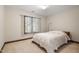 Bright bedroom with carpet, features a comfortable bed, window and a warm inviting ambiance at 12117 Cliffside Cir, Raleigh, NC 27614
