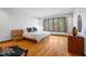 Bright bedroom featuring hardwood floors and a large window showcasing the natural outdoor scenery at 12117 Cliffside Cir, Raleigh, NC 27614