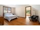 Bedroom with natural light and wooden floors, door leads to separate room at 12117 Cliffside Cir, Raleigh, NC 27614