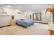 Spacious bedroom with a window, light-colored carpet, and unique built-in shelving for a modern touch at 12117 Cliffside Cir, Raleigh, NC 27614