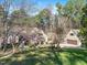 Charming home with lush greenery, mature trees, and a separate garage at 12117 Cliffside Cir, Raleigh, NC 27614