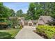 Charming home featuring a well-manicured lawn, mature trees, and a private driveway leading to a two-car garage at 12117 Cliffside Cir, Raleigh, NC 27614