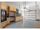 A garage with ample cabinetry and workspace, a garage door, and a clean, organized appearance at 12117 Cliffside Cir, Raleigh, NC 27614