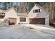 Three car garage featuring doors in brown color with a circular driveway at 12117 Cliffside Cir, Raleigh, NC 27614