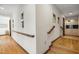 Bright hallway featuring hardwood floors, decorative mirrors, and built-in cabinetry at 12117 Cliffside Cir, Raleigh, NC 27614