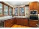 Gourmet kitchen featuring custom cabinets, granite countertops, stainless steel appliances, and a wine cooler at 12117 Cliffside Cir, Raleigh, NC 27614