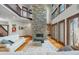 Open-concept living room with a stone fireplace and hardwood floors at 12117 Cliffside Cir, Raleigh, NC 27614