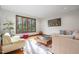 Bright living room featuring hardwood floors, a large window with nature views, and comfortable modern furnishings at 12117 Cliffside Cir, Raleigh, NC 27614