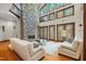 Comfortable living room showcasing a stone fireplace and lots of light at 12117 Cliffside Cir, Raleigh, NC 27614