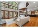 Spacious living room with hardwood floors, and large windows overlooking nature at 12117 Cliffside Cir, Raleigh, NC 27614