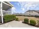 Spacious backyard with mature landscaping and a covered porch at 1212 Stonemill Falls Dr, Wake Forest, NC 27587