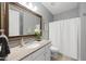 Well-lit bathroom featuring a granite vanity with a large mirror, providing a clean and bright space at 1212 Stonemill Falls Dr, Wake Forest, NC 27587